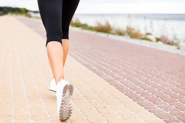 istock Woman running at seaside 1141133679