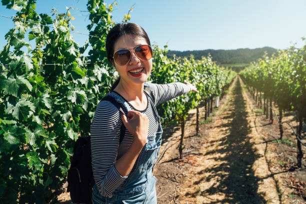 istock girl in sunglasses pointing in grape winery 1141135534