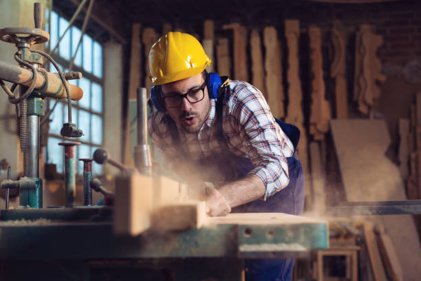 istock Carpenter cutting wooden plank 1141141021