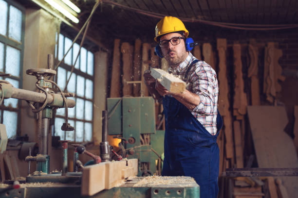 istock Carpenter doing his job in carpentry workshop 1141142423