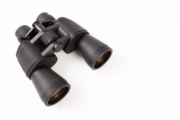 istock Black binoculars with orange lens isolated on white background 1141143022