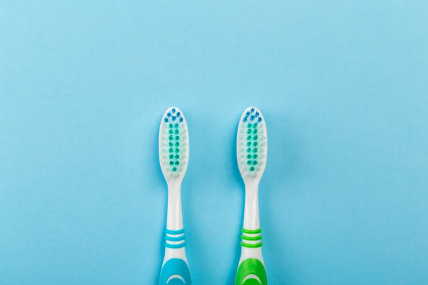 istock Two new toothbrush on a blue background. Dental concept 1141144097