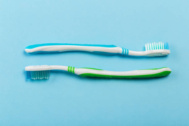 istock Two new toothbrush on a blue background. Dental concept 1141144602