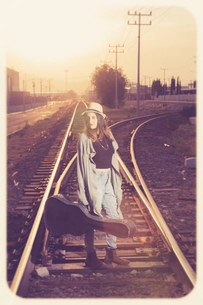 istock Woman in sunset with a guitar 1141144662