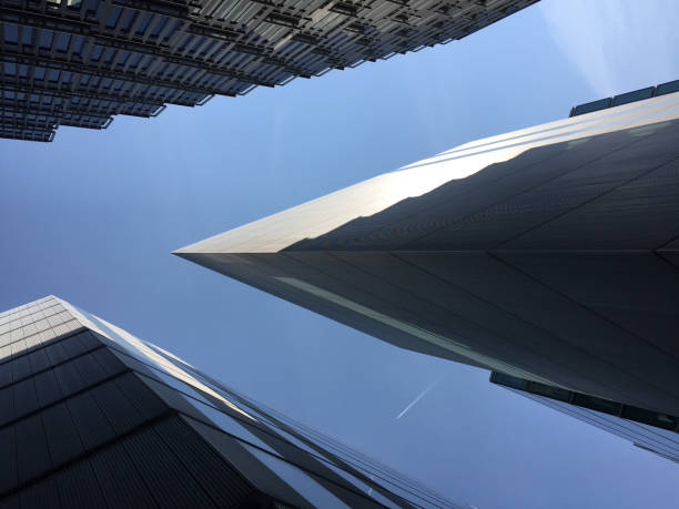 istock Dramatic view of modern architecture with a plane passing through a clear blue sky in south central London. 1141145467