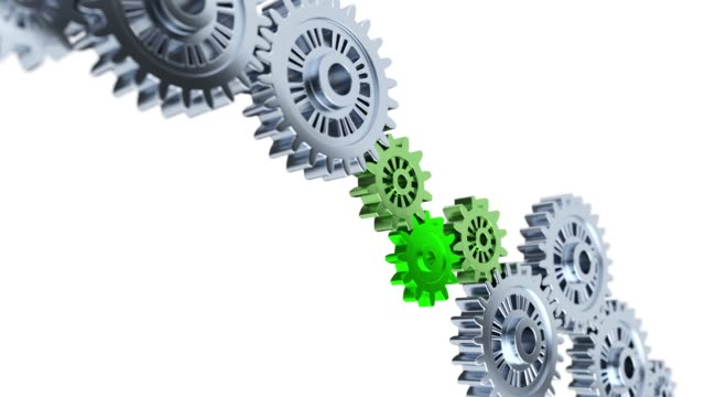 Focus on Three Green Gears with Some Gray and blurred Gears in Infinite Rotation