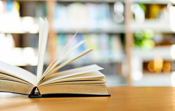 istock An open book on the table of public library 1141148479