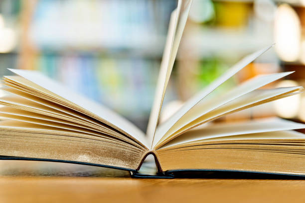 istock An open book on the table of public library 1141148527