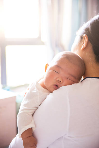 istock Mother holding her sleeping baby 1141148552
