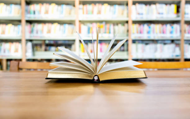 istock An open book on the table of public library 1141148573