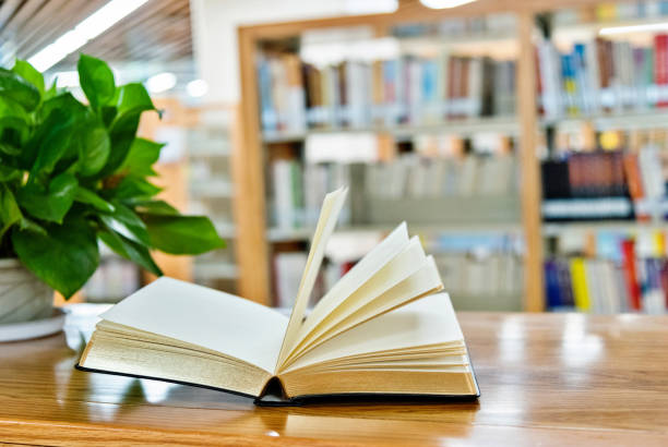 istock An open book on the table of public library 1141148695
