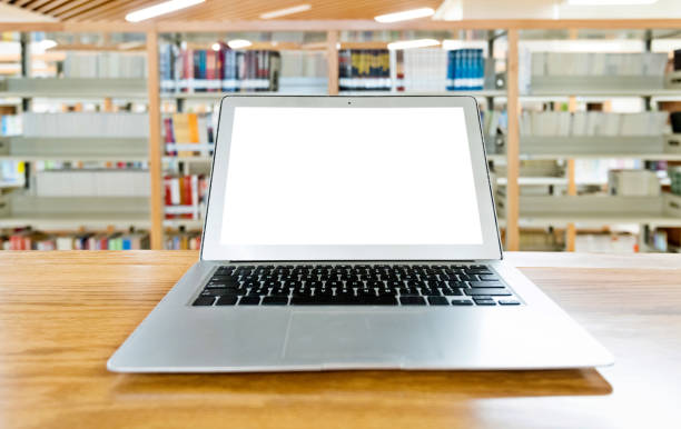 istock Laptop with blank screen in the table of public library 1141149756