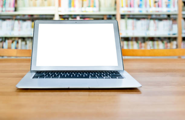 istock Laptop with blank screen in the table of public library 1141149787