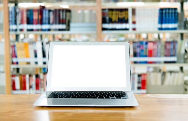 istock Laptop with blank screen in the table of public library 1141149789
