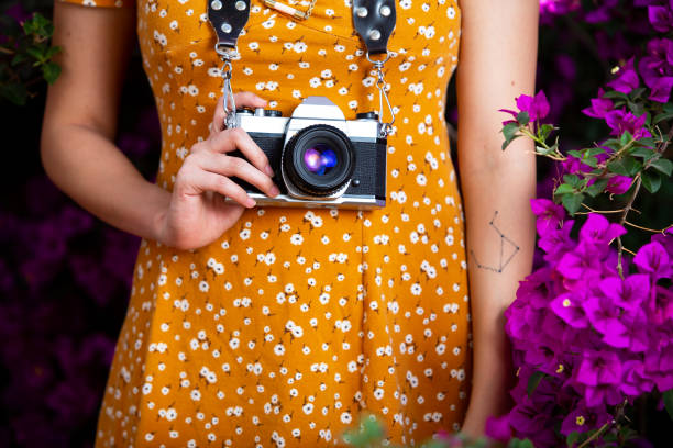 istock Young woman with flowers background 1141153276