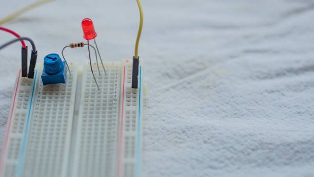 istock Potentiometer, resistors and red LED set up on a breadboard 1141154049