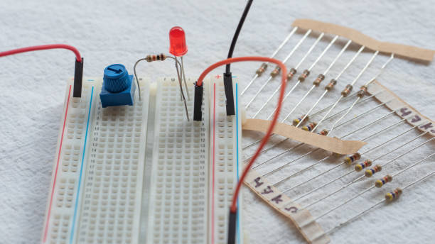 istock Potentiometer, resistors and red LED set up on a breadboard 1141154061
