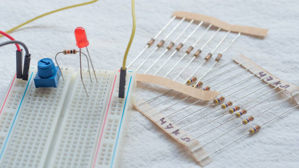 istock Potentiometer, resistors and red LED set up on a breadboard 1141154090
