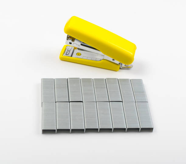 istock Yellow Office Stapler on Side with Staples Isolated 1141154284