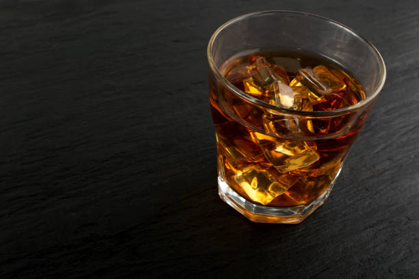 istock Iced Whiskey Glass on Natural Black Stone Background 1141154287