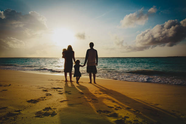 istock happy family with kid play on sunset beach 1141154300