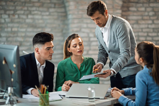 istock Businessman cooperating with his team while using touchpad on a meeting. 1141154827