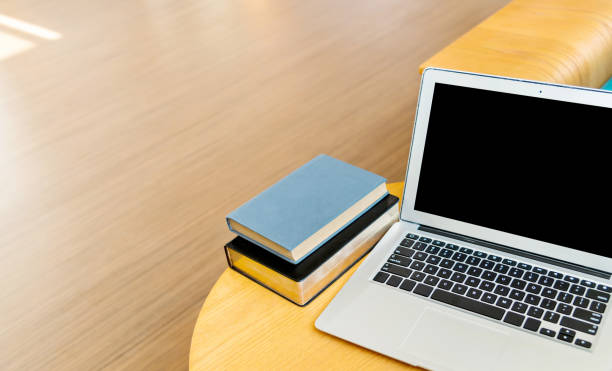 Laptop and books on the coffee table.