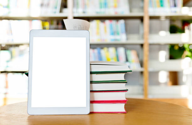 istock Digital tablet and books on the table of public library 1141154927