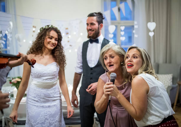 istock A young bride and groom with other guests dancing and singing on a wedding reception. 1141156300