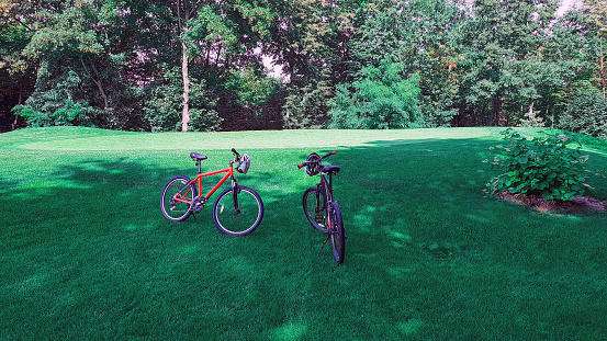two bicycles on green grass