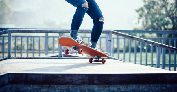 istock Skateboarder skateboarding at skatepark ramp 1141157962