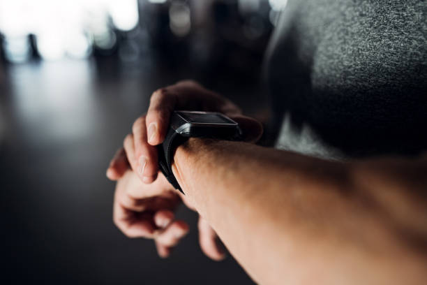 istock A midsection of man in gym measuring time while doing exercise. Copy space. 1141158047