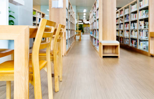 istock Empty wooden tables and chairs in public library 1141159252