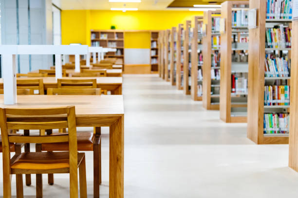 istock Empty wooden tables and chairs in public library 1141159763