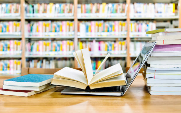 istock Open book on the laptop keyboard 1141161159