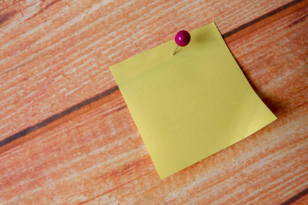 istock Close-Up Of Yellow Adhesive Note On Wooden Table 1141163211
