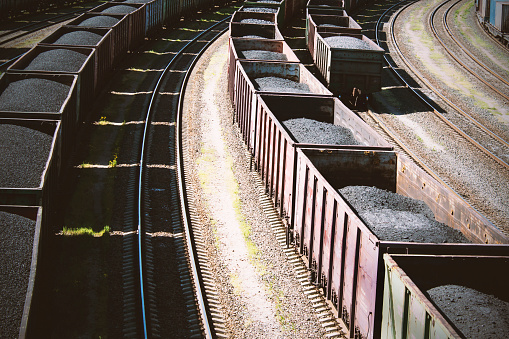 rail cars loaded with coal, a train transports coal.