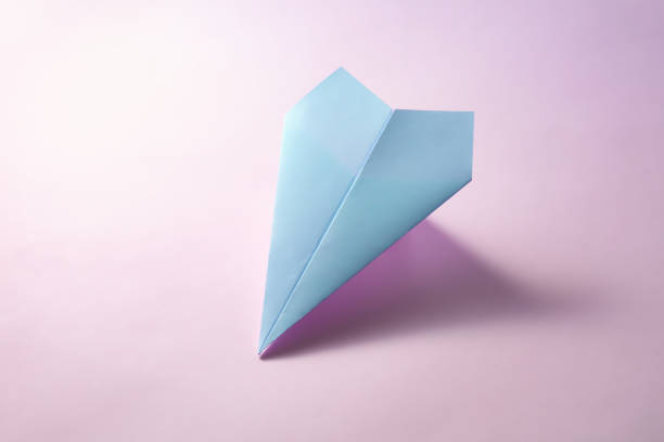 istock paper airplane on pastel background. Minimal flat lay school concept. 1141163788