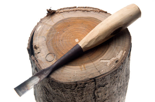 istock Close-Up Of Chisel With Log Over White Background 1141164511