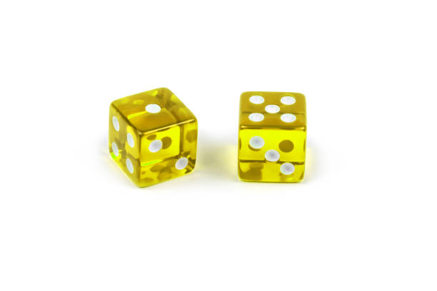 istock Two yellow glass game dice isolated on white background. One and five. 1141165838