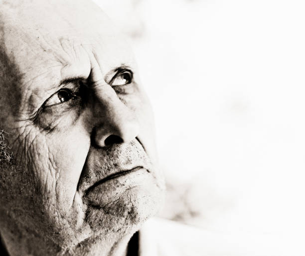 istock Senior man looks upwards to the side, seeming anxious 1141167055
