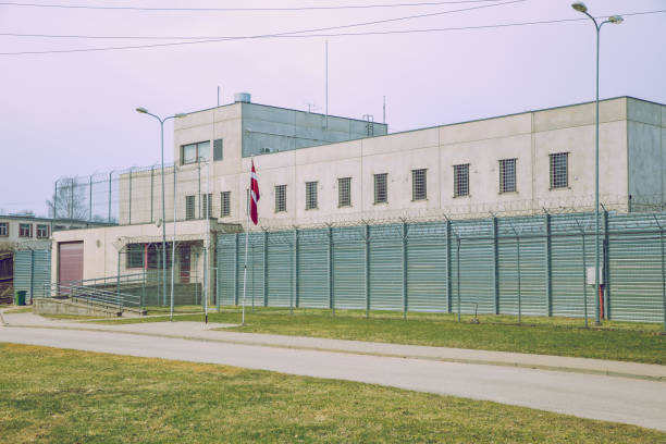 City Cesis, Latvia. Criminal prison, white building with grilles and iron fences. Travel photo 2019, 07.04.