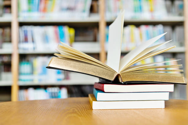 istock Open book on the desk of library 1141169475