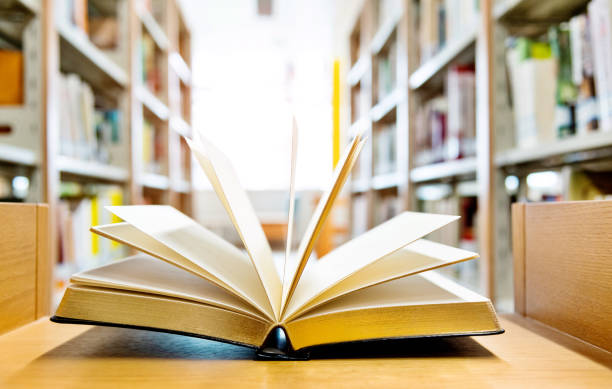 istock Open book on the desk of library 1141169539