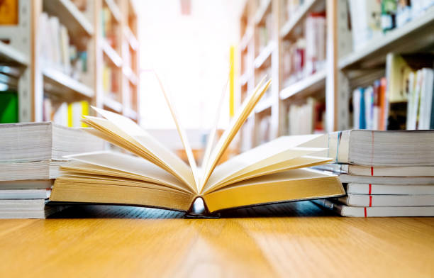 istock Open book on the desk of library 1141169601