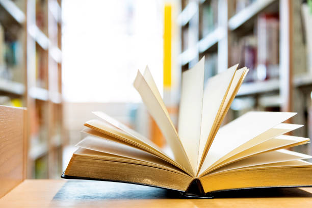 istock Open book on the desk of library 1141169634