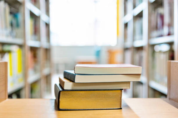 istock Stack of books on the desk of library 1141169744