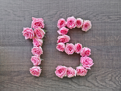 Vintage number of pink roses on the background of dark wood - for congratulations, postcards, websites, design, printing