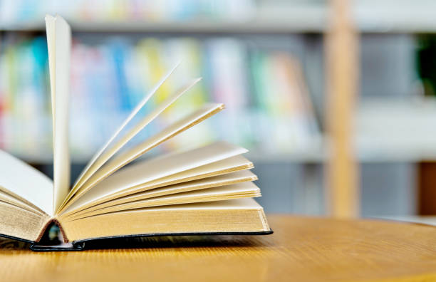 istock Open book on the desk of library 1141169991