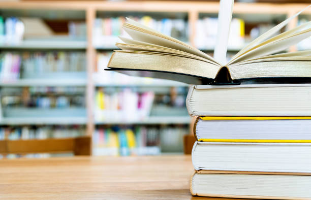 istock Open book on the desk of library 1141170202